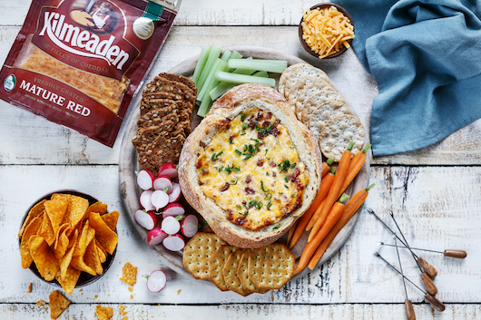 Bread Bowl with Cheddar bacon surrounded by a range of sides.